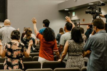 Small group worshipping together at a local church plant gathering